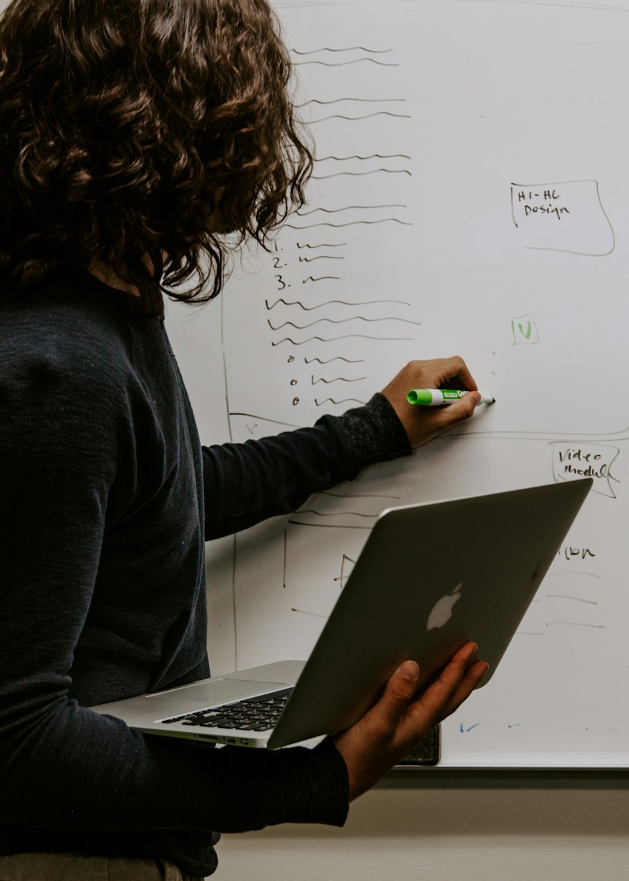 A teammate mapping out a plan on a whiteboard